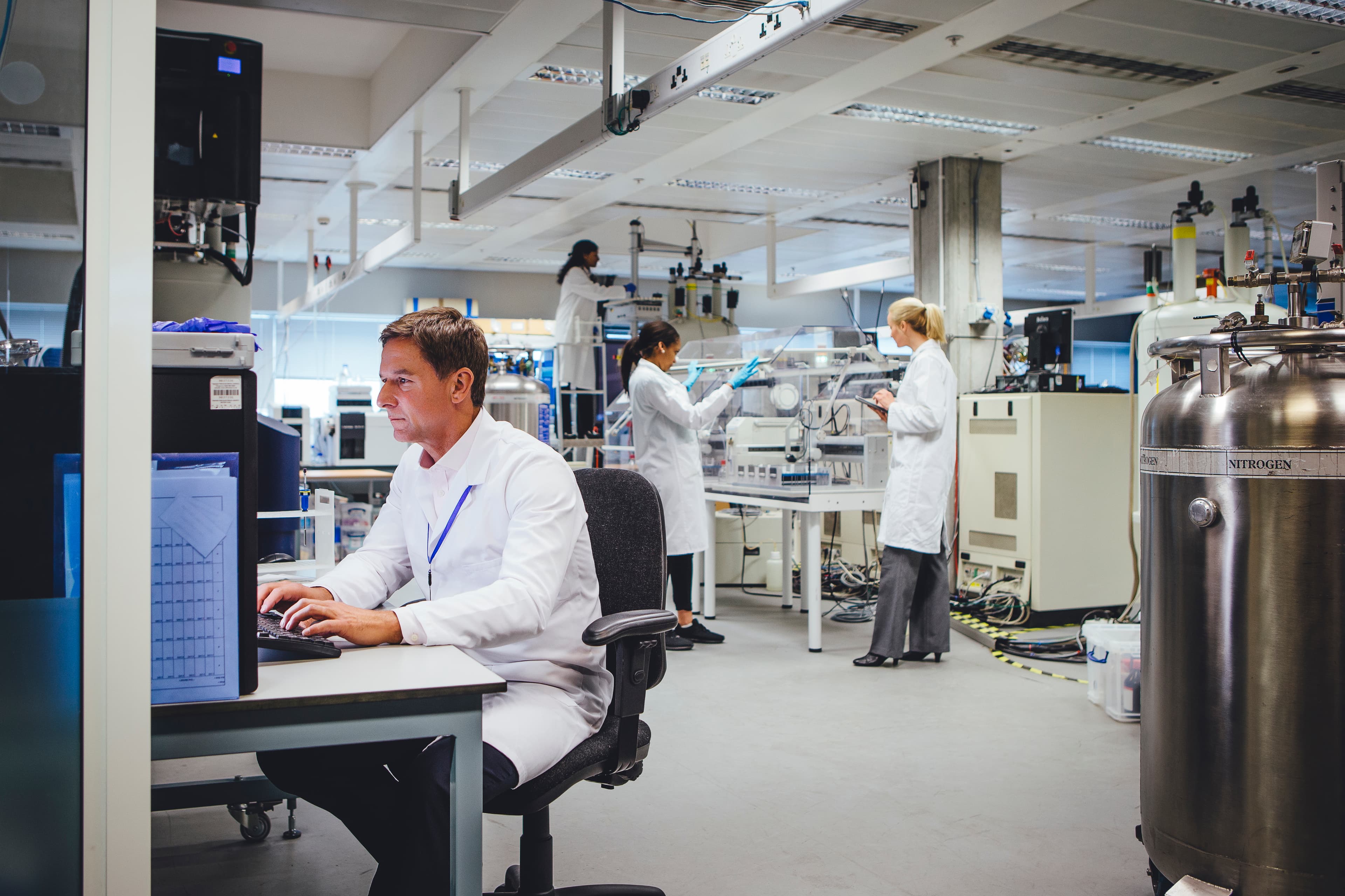 Group of medical science professionals working in a laboratory.